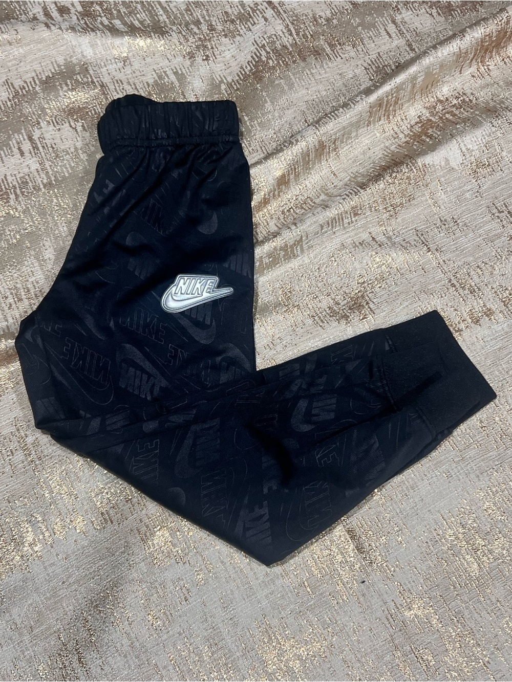 Nike black sweatpants with repeating Nike logo pattern youth small